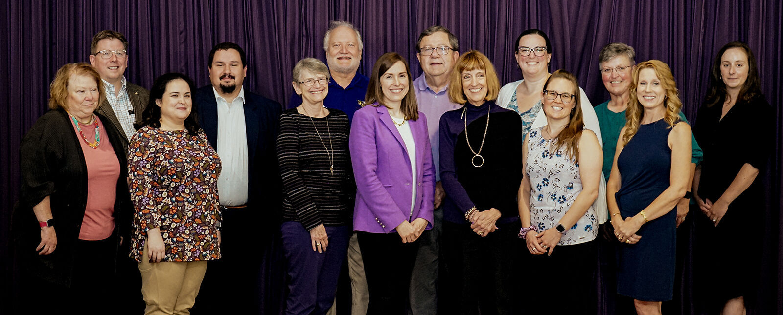 Alumni Board Members stand for a group shot. 