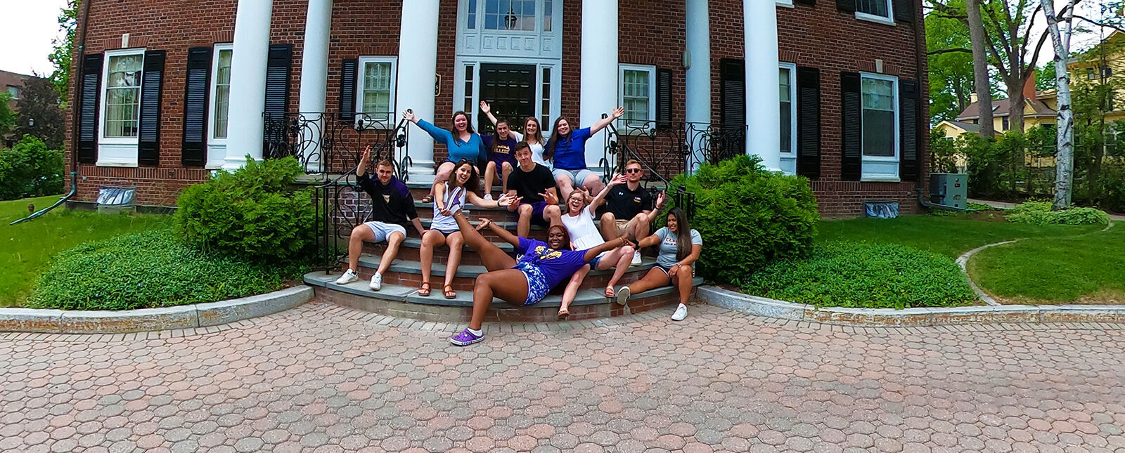 Students cheer on the steps of the Admissions House