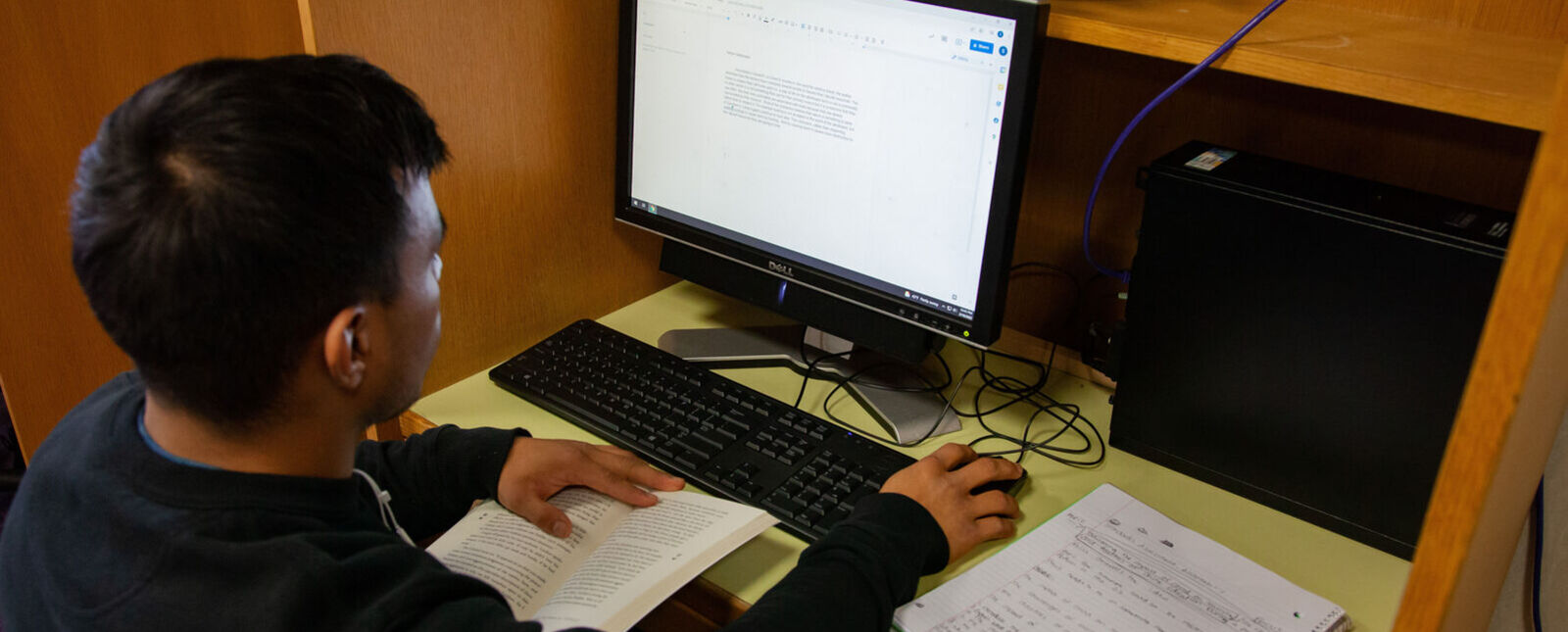 A male student works at a computer