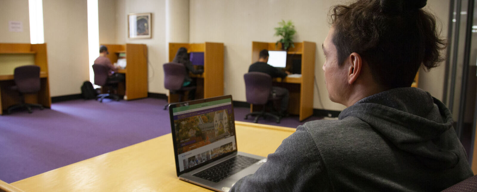 An employee monitors test takers in the Center for Academic and Professional Excellence