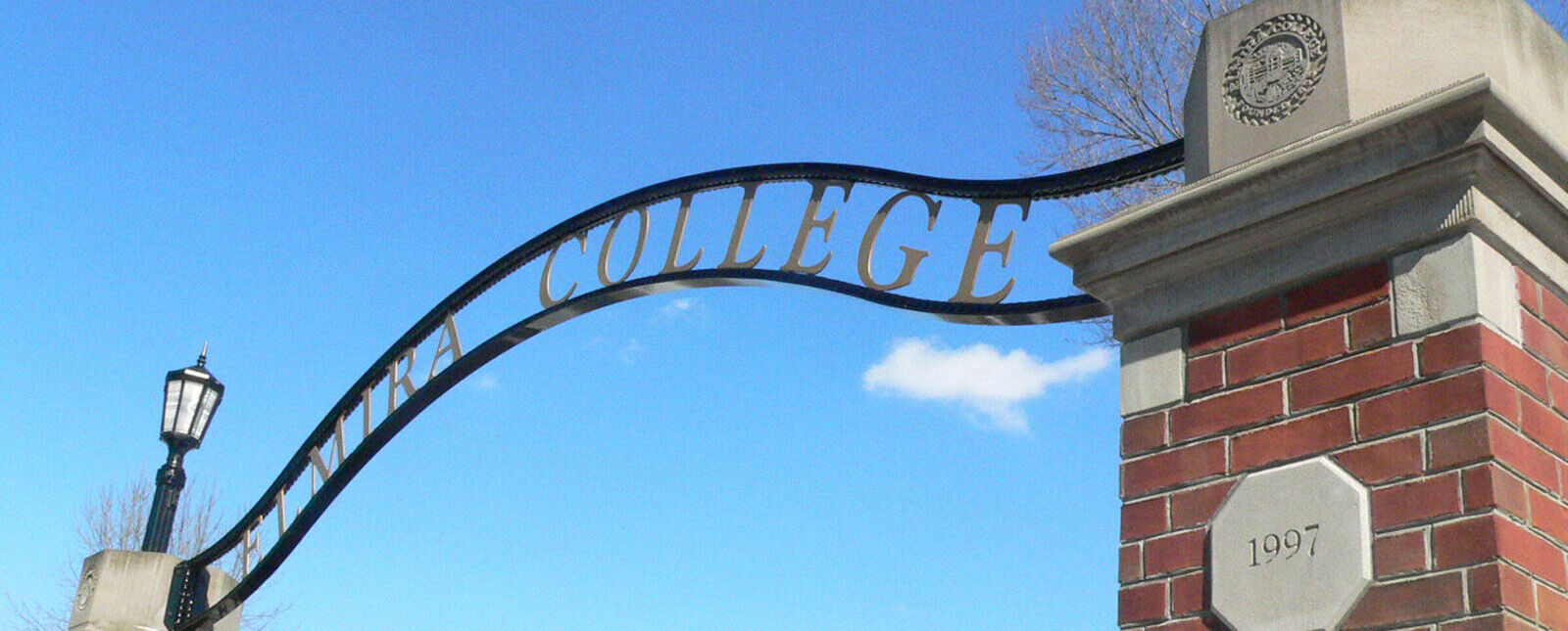 An Elmira College gateway stands on a corner of the campus