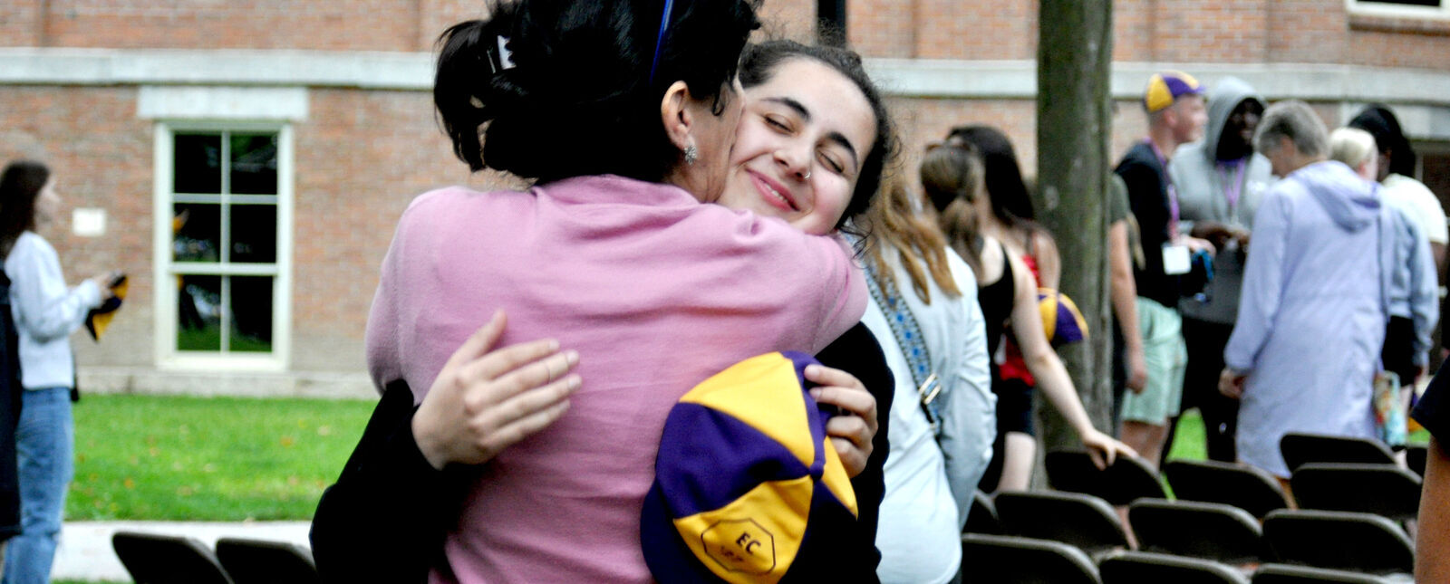 A mother and her daughter share a hug during the Fall Welcome