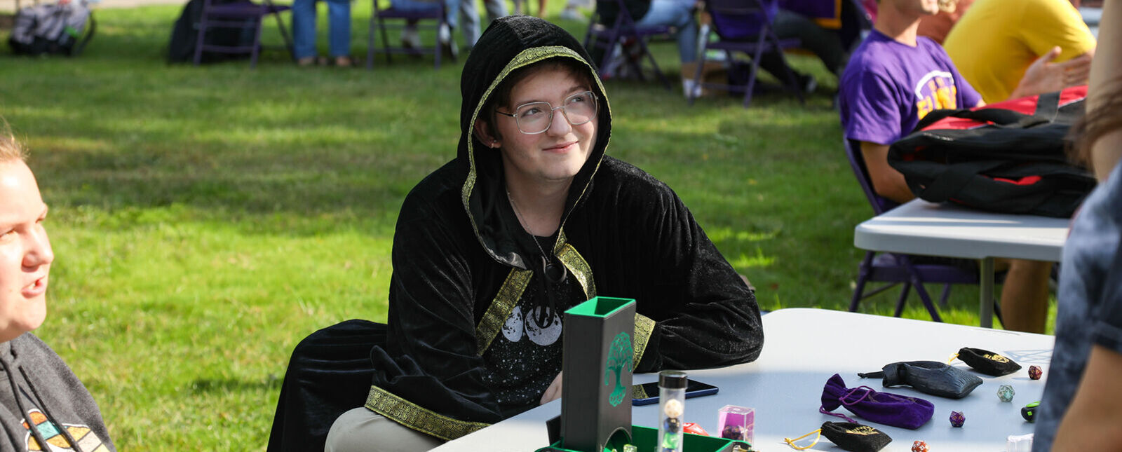 A student greets visitors to the Dungeons and Dragons Club table during an activities fair