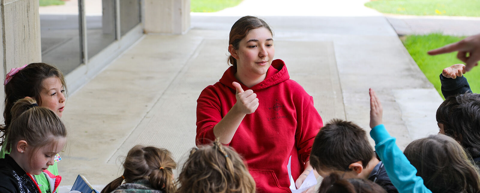 A teaching student works with children visiting the Elmira College campus