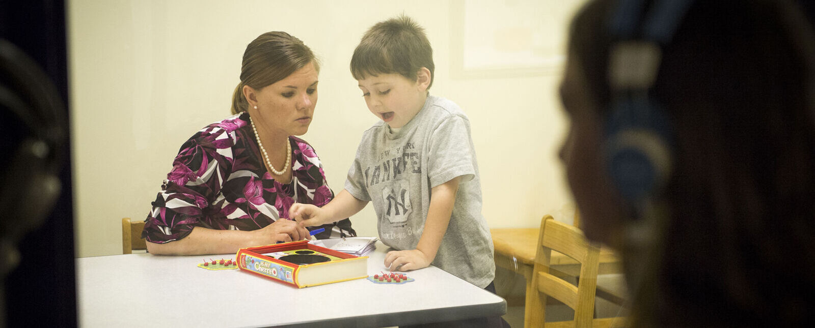 A student helps a child in the Elmira College Speech and Hearing Clinic